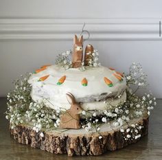 a cake decorated with white frosting and carrots