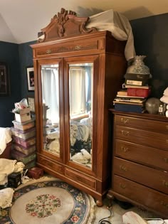 an old fashioned armoire in a bedroom