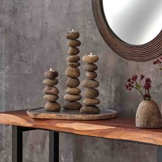 a mirror and some rocks on a table