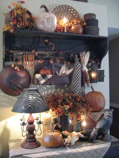 a shelf filled with lots of pumpkins and other decorative items on top of a table