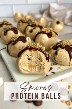 some chocolate covered doughnuts on a white plate with the words smores protein balls