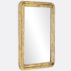 a gold framed mirror hanging on the wall