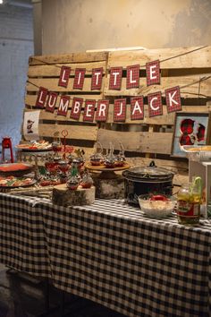 a table topped with lots of food next to a sign that says little lumber jack