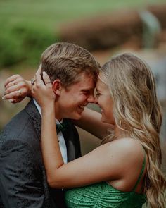 a young man and woman embracing each other