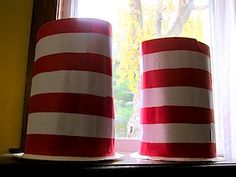 two red and white hats sitting on top of a window sill