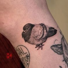 a small bird tattoo on the leg