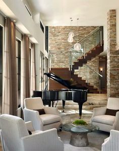 a living room filled with furniture and a grand piano