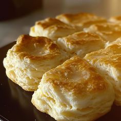 some biscuits are sitting on a black plate