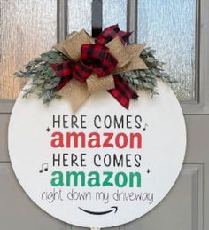 a christmas door hanger that says here comes amazon here comes amazon right down my driveway