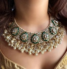 Adorn yourself with exquisite Bridal Kundan Jewellery in stunning shades of green and off white pearls. This Wedding jewellery, inspired by Indian and Pakistani traditions, features intricate designs including Jhumka earrings, Maangtika (forehead ornament), and Punjabi-inspired elements.  With vibrant ivory accents and green Meenakari work, this jewellery set is the perfect complement to your Indian wedding ensemble, radiating timeless beauty and capturing the essence of cultural heritage. Item includes: Necklace, earrings and maangtika Ready to be shipped with love from New Delhi, India  Please leave your phone number in notes or message when placing order for this item. Luxury Green Bridal Necklace For Diwali, Pista Green Jewellery Set, Luxury Green Meenakari Jhumkas, Heeramandi Jewellery, Heeramandi Aesthetic, Mint Green Jewelry, Balmain Bag, Kundan Choker Necklace, Kundan Jewellery Bridal