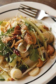 a white plate topped with pasta and veggies