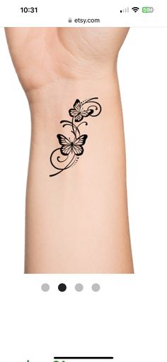 a small tattoo on the wrist that is black and white with an intricate flower design