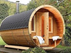 a wooden sauna in the middle of a garden