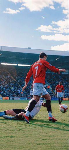 two men are playing soccer on the field