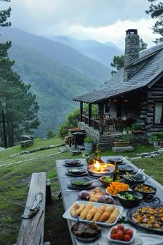 a table with food on it in front of a cabin