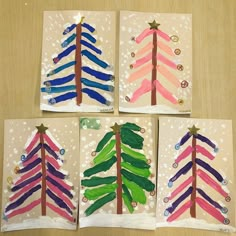 four handmade christmas cards with colorful trees on them