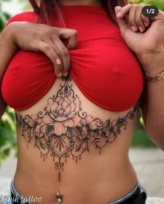 a woman with tattoos on her stomach is posing for the camera while wearing a red top