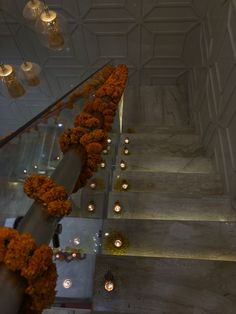 flowers and candles are lined up on the stairs in this building's lobby area