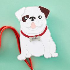 a white and brown dog with a red leash attached to it's neck on a green background