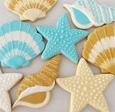 cookies decorated like seashells and starfish on a white table with the caption oh sugarevents