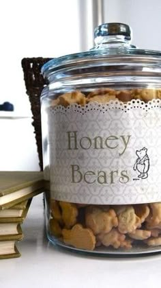 a glass jar filled with cookies sitting on top of a table next to a stack of books