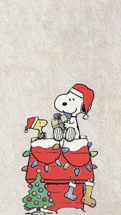 a snoopy christmas card with a dog sitting on top of it