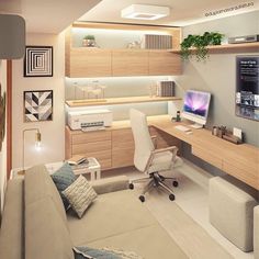 a room with a couch, desk and computer monitor on the wall next to it