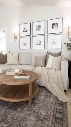 a living room filled with furniture and pictures on the wall