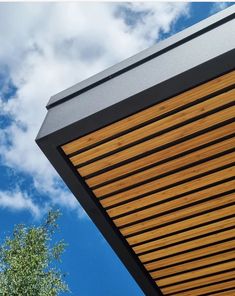 a close up view of the top of a building with wood slats on it