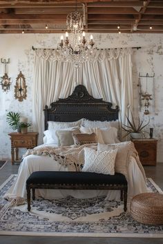 a large bed sitting under a chandelier in a bedroom