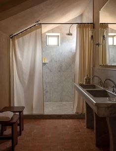 a bath room with a sink a mirror and a shower