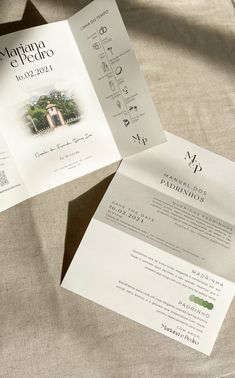 an open brochure on top of a bed with sheets and pillows in the background