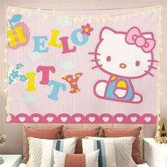 a hello kitty wall hanging above a bed