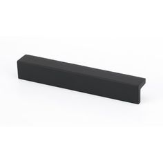 a black rectangular object sitting on top of a white surface