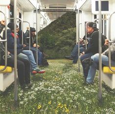 people are sitting on the bus with their backs to each other