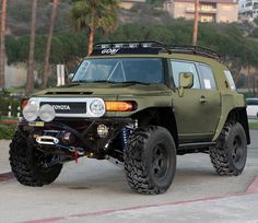 an off - road vehicle is parked on the street