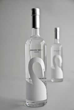 two bottles of vodka sitting next to each other