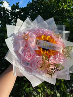 someone is holding a bouquet of flowers with butterflies on it and the words welcome are written in white letters