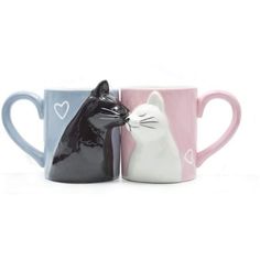 two coffee mugs with cats on them, one has a heart and the other has a cat's head