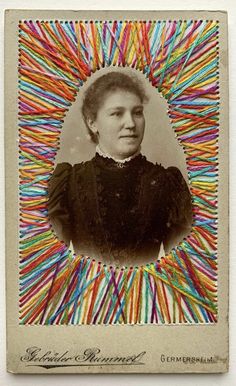 an old photo of a woman with colorful sticks in her hair