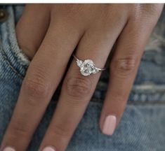 a woman's hand with a diamond ring on it