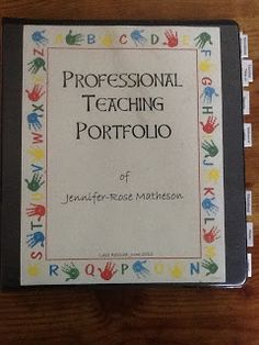 a book on professional teaching with handprinted letters and hands around the cover, sitting on a wooden surface