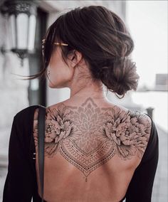 a woman with a tattoo on her back