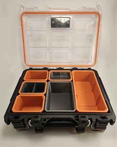 an orange and black case filled with compartments