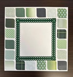 a piece of paper with green and gray squares on it, in the shape of a square