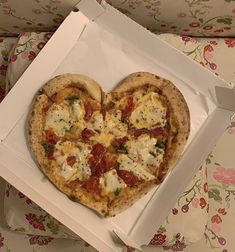 a heart shaped pizza in a white box