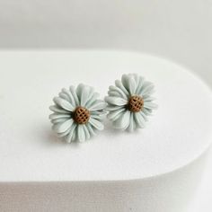 Light blue floral daisy stud earrings. Featuring light blue floral resin cabochons. Securely attached to silver metal ear posts. The sweetest pair of earrings. Makes a great gift for her or a treat for yourself. * SHIPS in 1 Business Day! * Shop with Confidence! * We are a 5 Star Rated Shop operating since 2007! D E T A I L S - Floral bloom measures 14mm. - Silver plate metal posts. - Blooms are high quality resin. Due to different monitor settings colour can appear slightly different than the item. C A R E ∙ I N F O - Always remove before bed. - Remove prior to showering and swimming. - Keep away from harsh chemicals and oils. - Store with like items. - Keep away from high humidity. - To clean, wipe gently with a soft cotton cloth. H A N D M A D E ∙ W I T H ∙ L O V E * I hand make all pie Daisy Studs, Floral Studs, Teenage Girl Gifts, Daisy Earrings, Resin Flowers, Feature Light, Pretty Gift, Jewelry For Her, Flower Jewellery