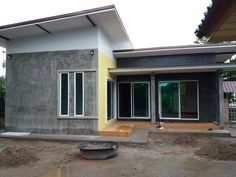 a house being built in the middle of a construction area with concrete walls and windows