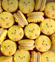 many yellow macaroons with faces and eyes are arranged in a pattern on a table