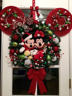 mickey and minnie mouse christmas wreath hanging on the front door